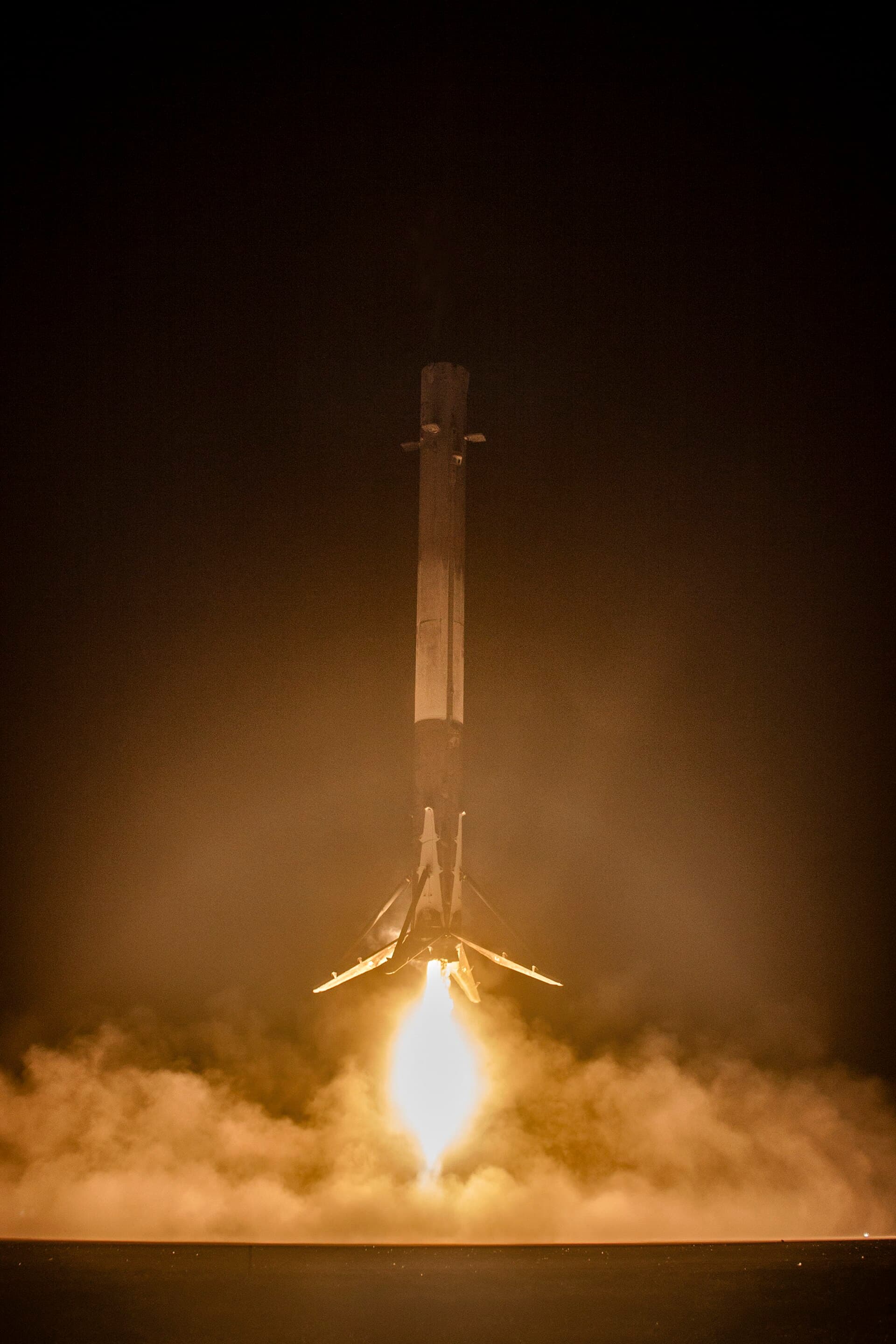The Falcon 9 booster descending under power during the first successful ground landing.